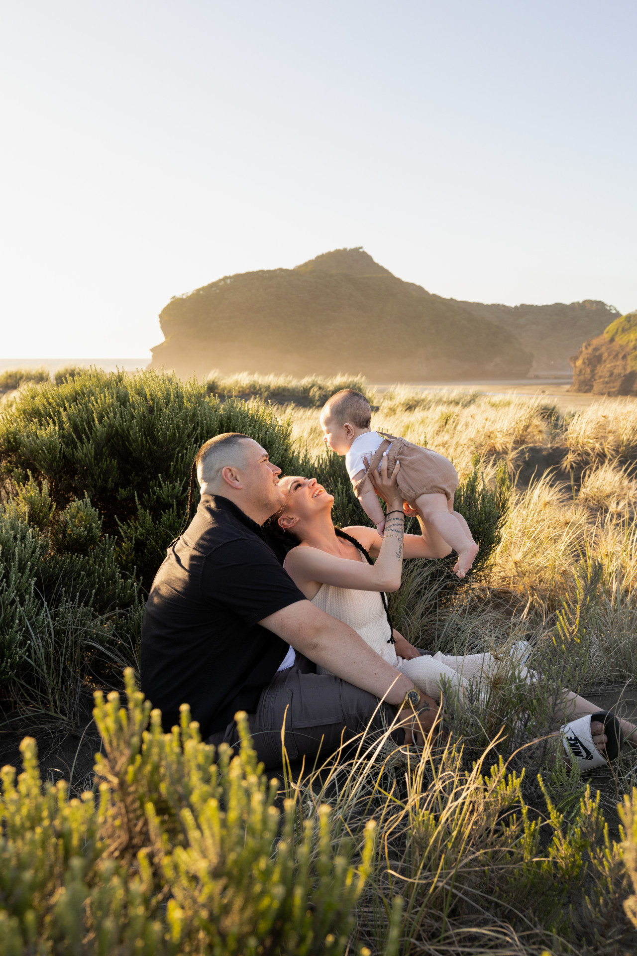 family photo of parents playing with child