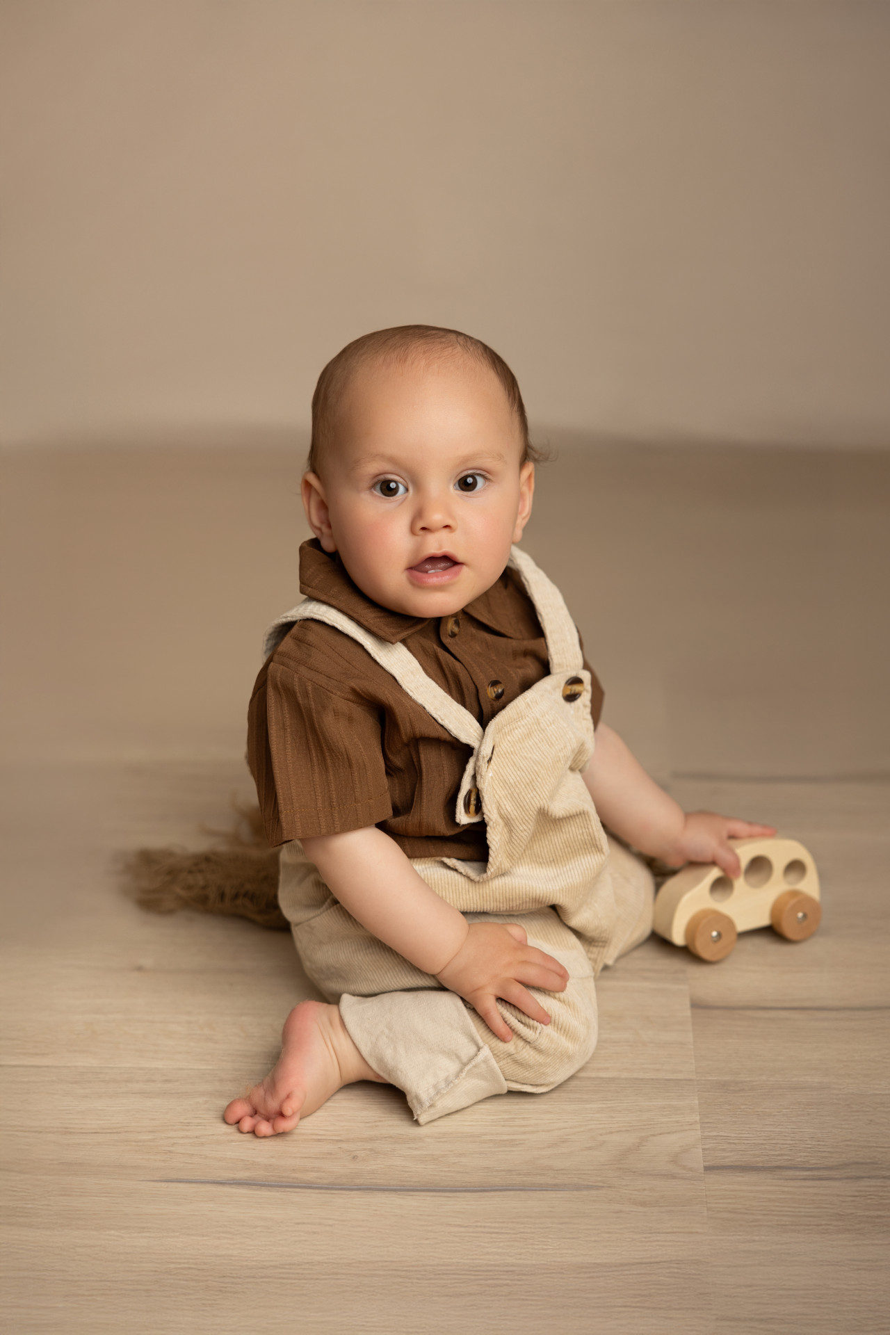 baby sitting on the floor playing