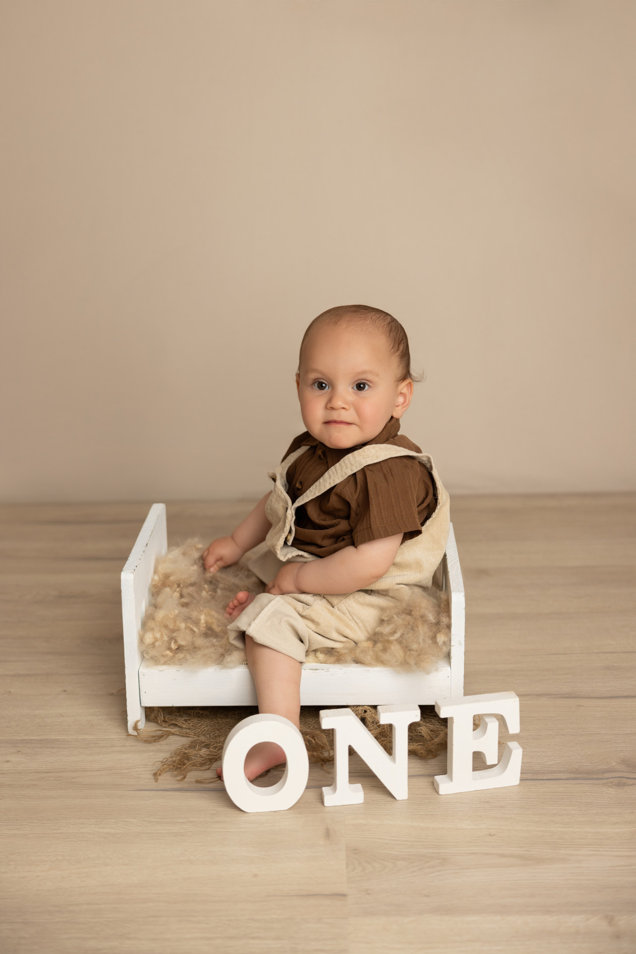 baby sitting on baby bed