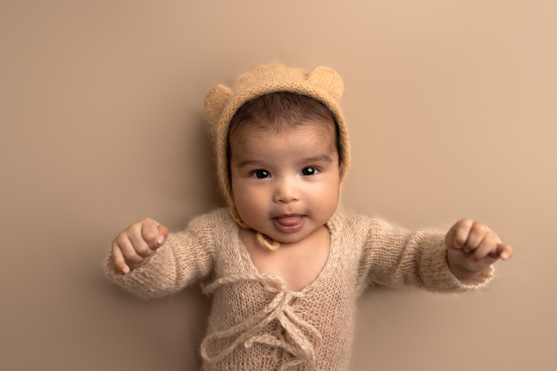 baby dressed in teddy outfit