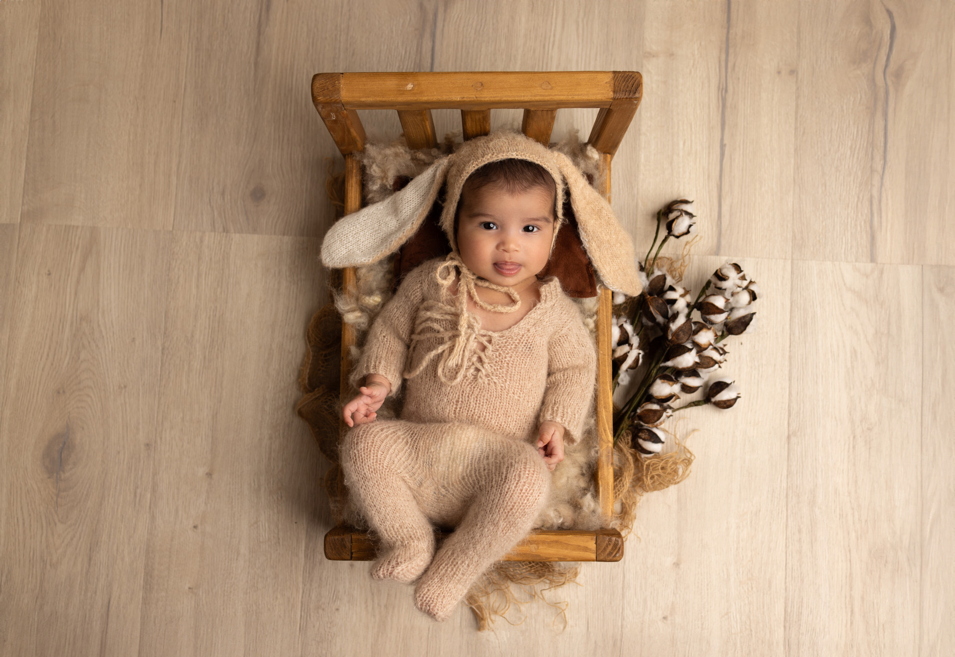 baby with bunny ears in basket