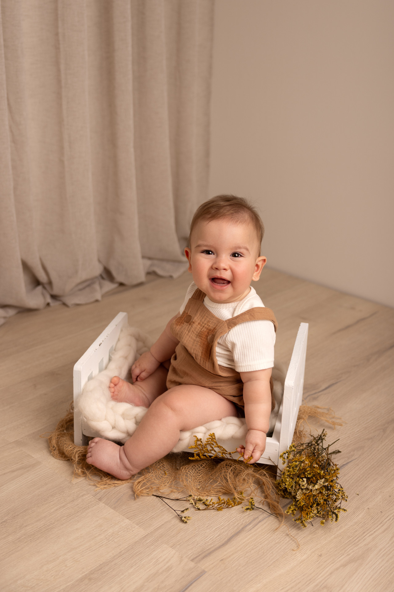 baby sitting on baby bed