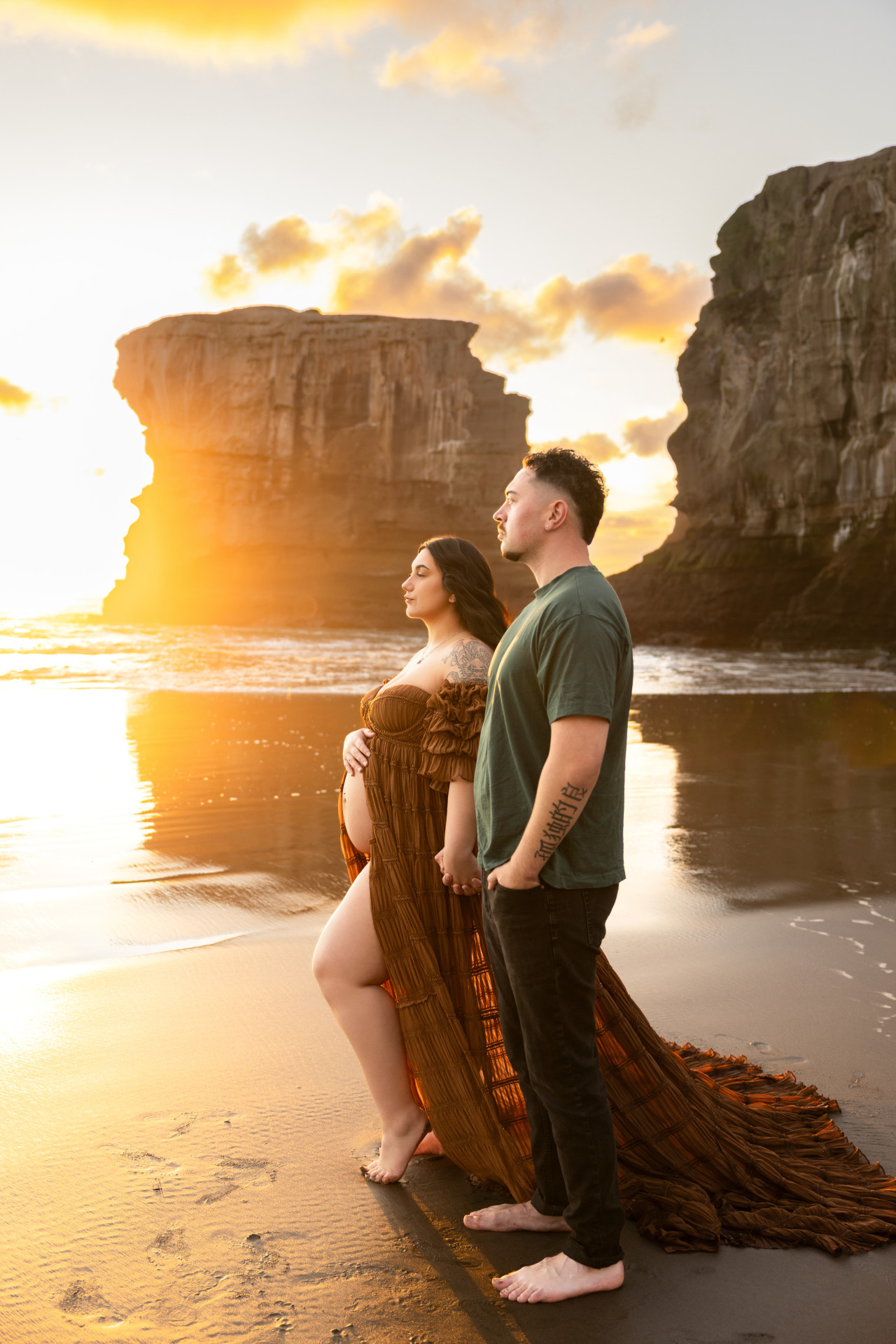 couple looking at sunset during pregnancy shoot