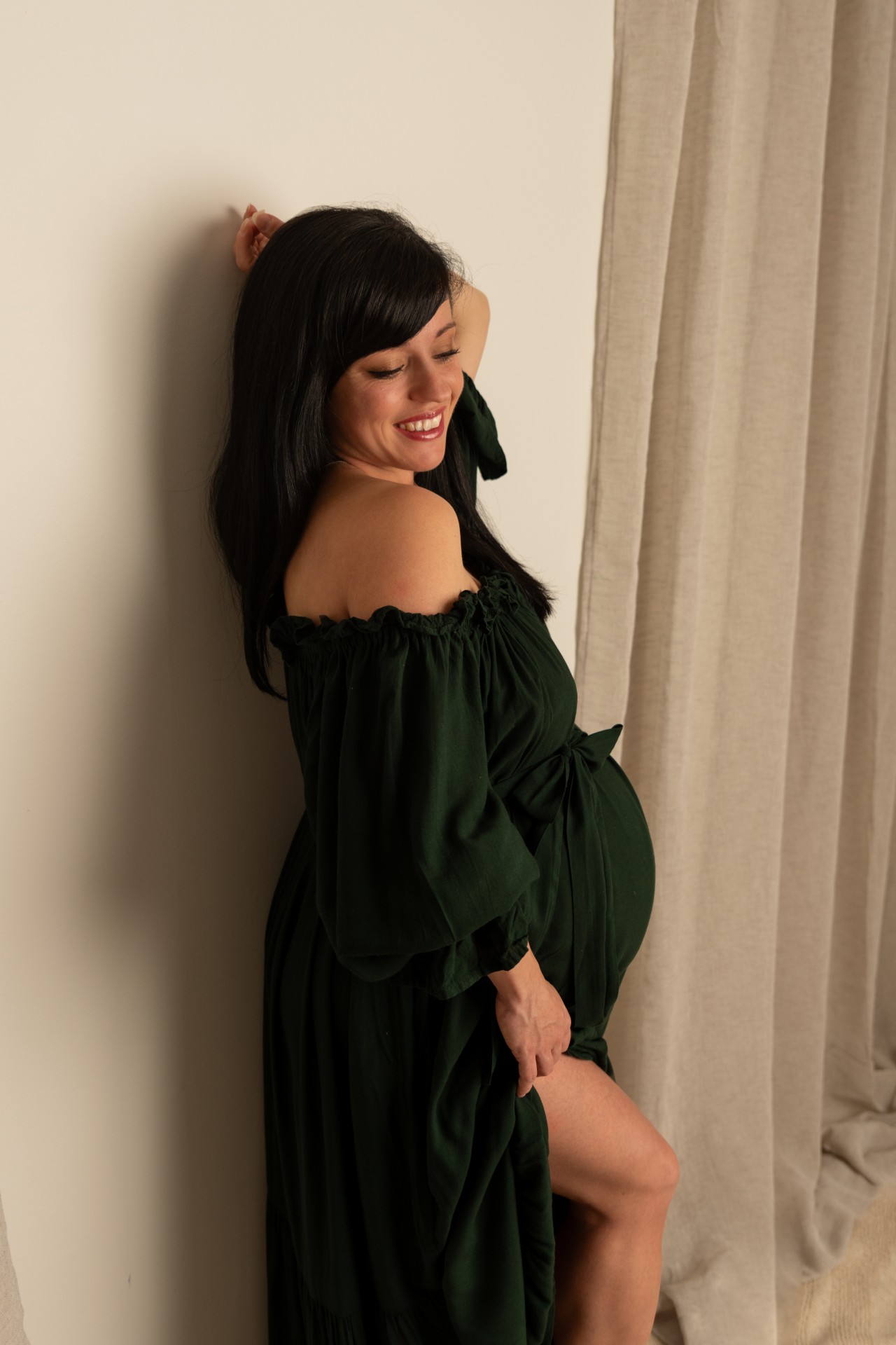 woman in the green dress smilling 