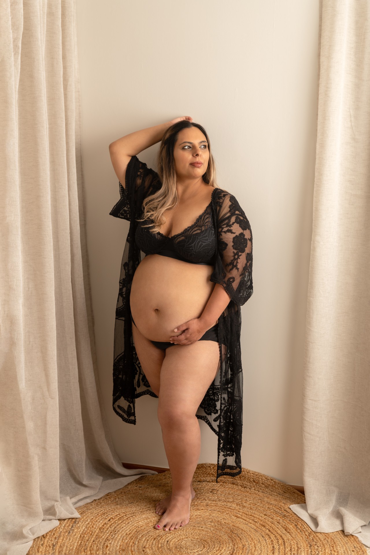 Pregnant woman in the black lace robe