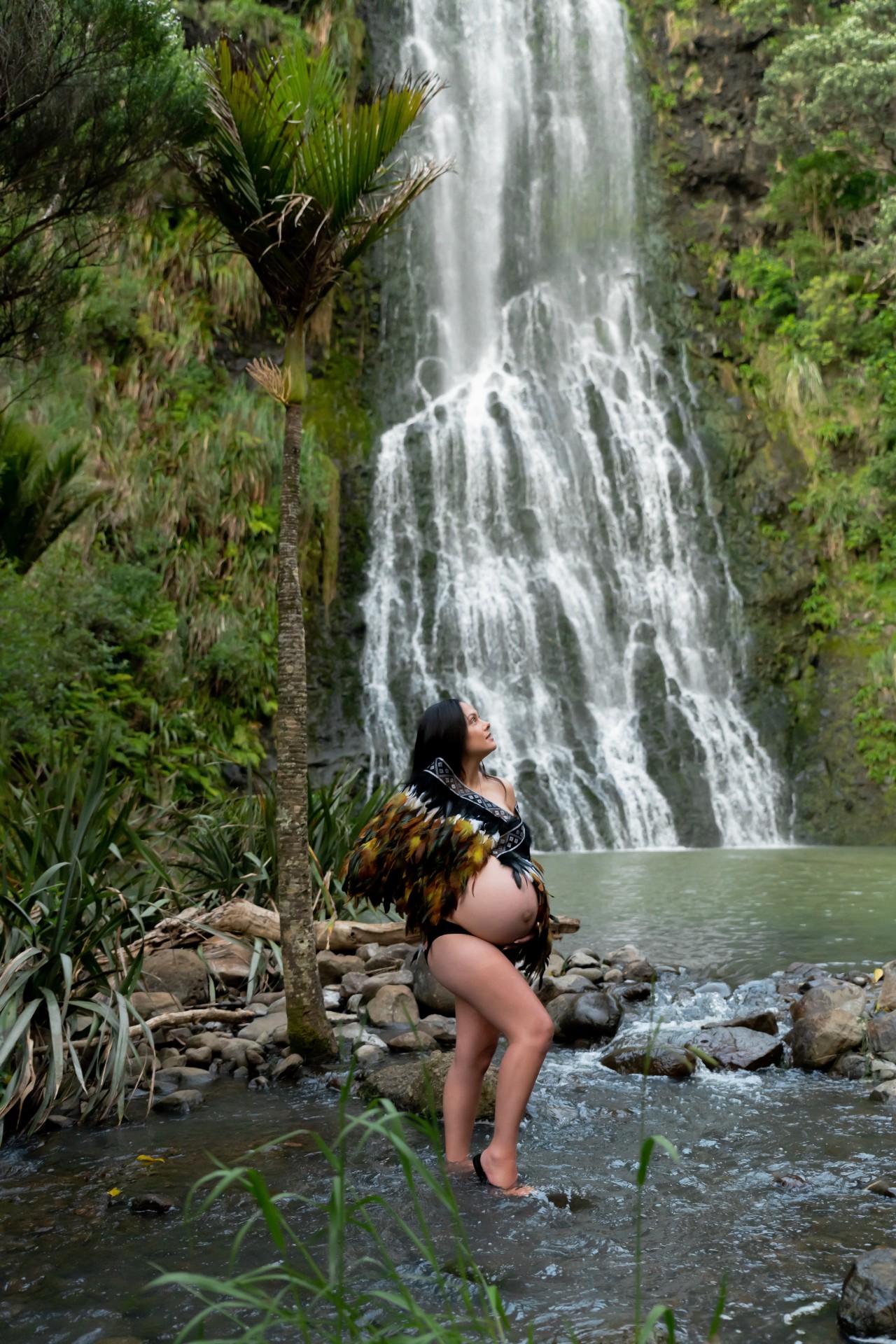 Waterfall maternity session with the lady wearing korrowai