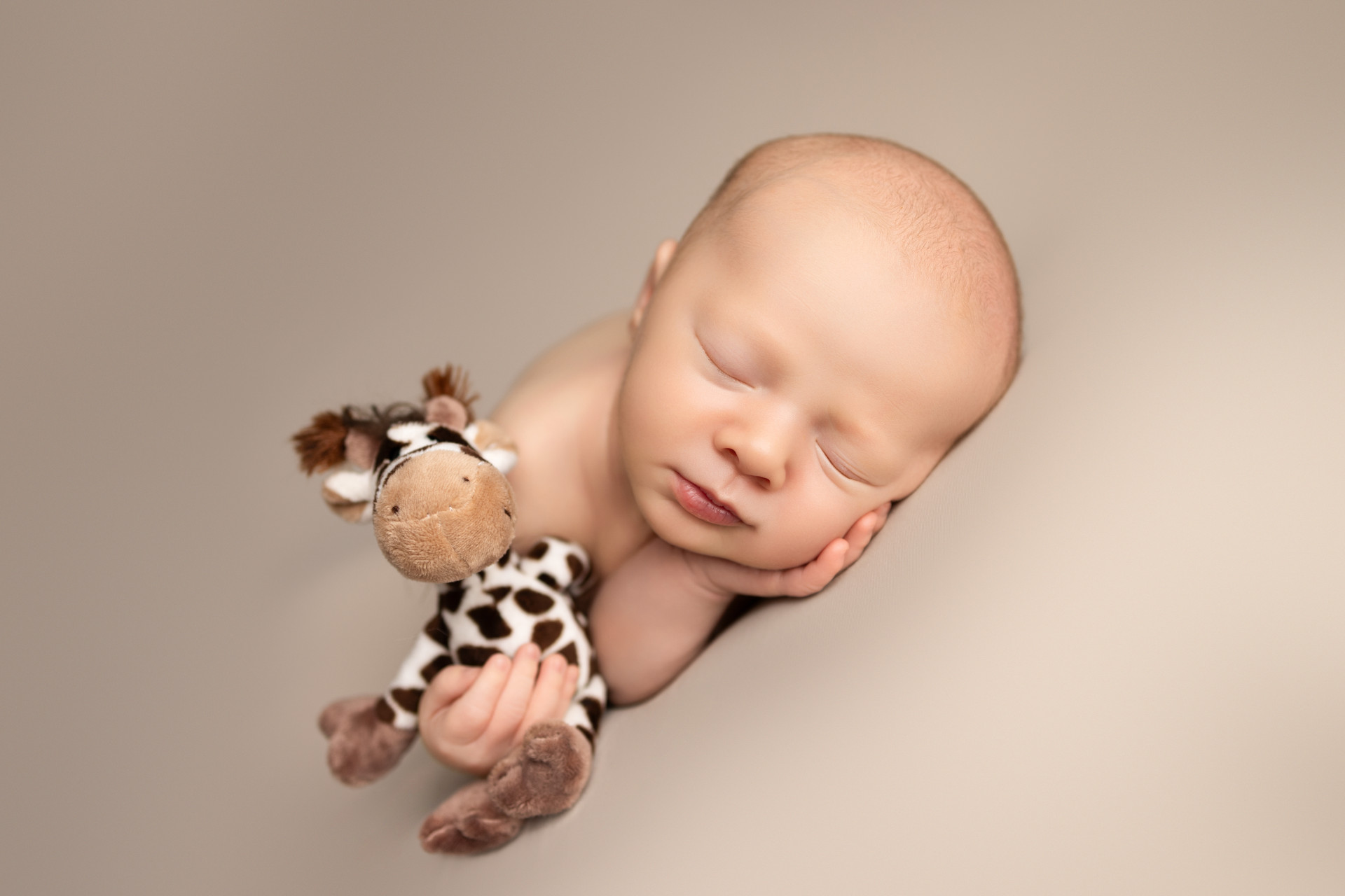 baby cuddling toy giraffe