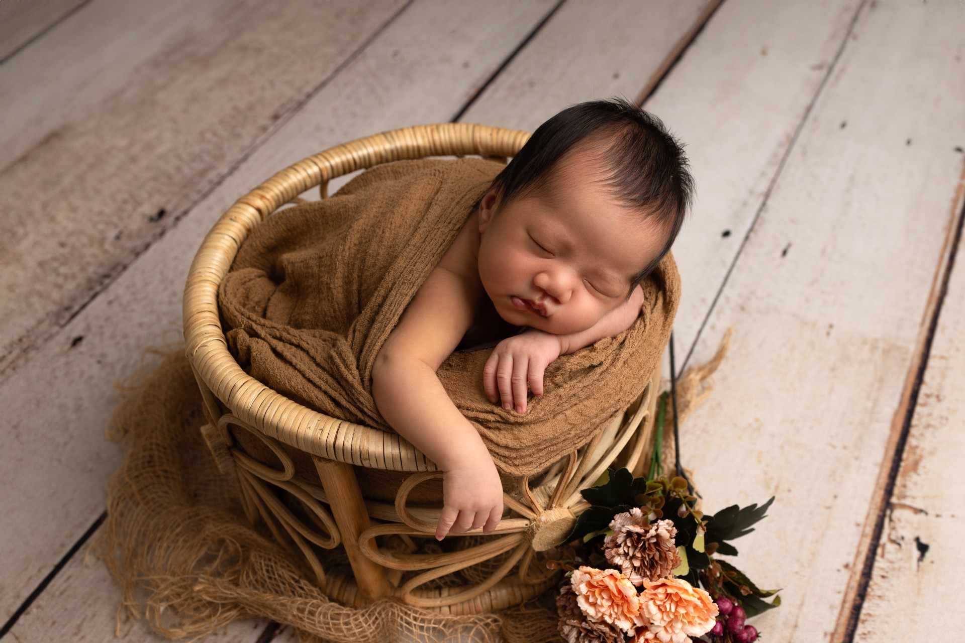 baby in floral bowl