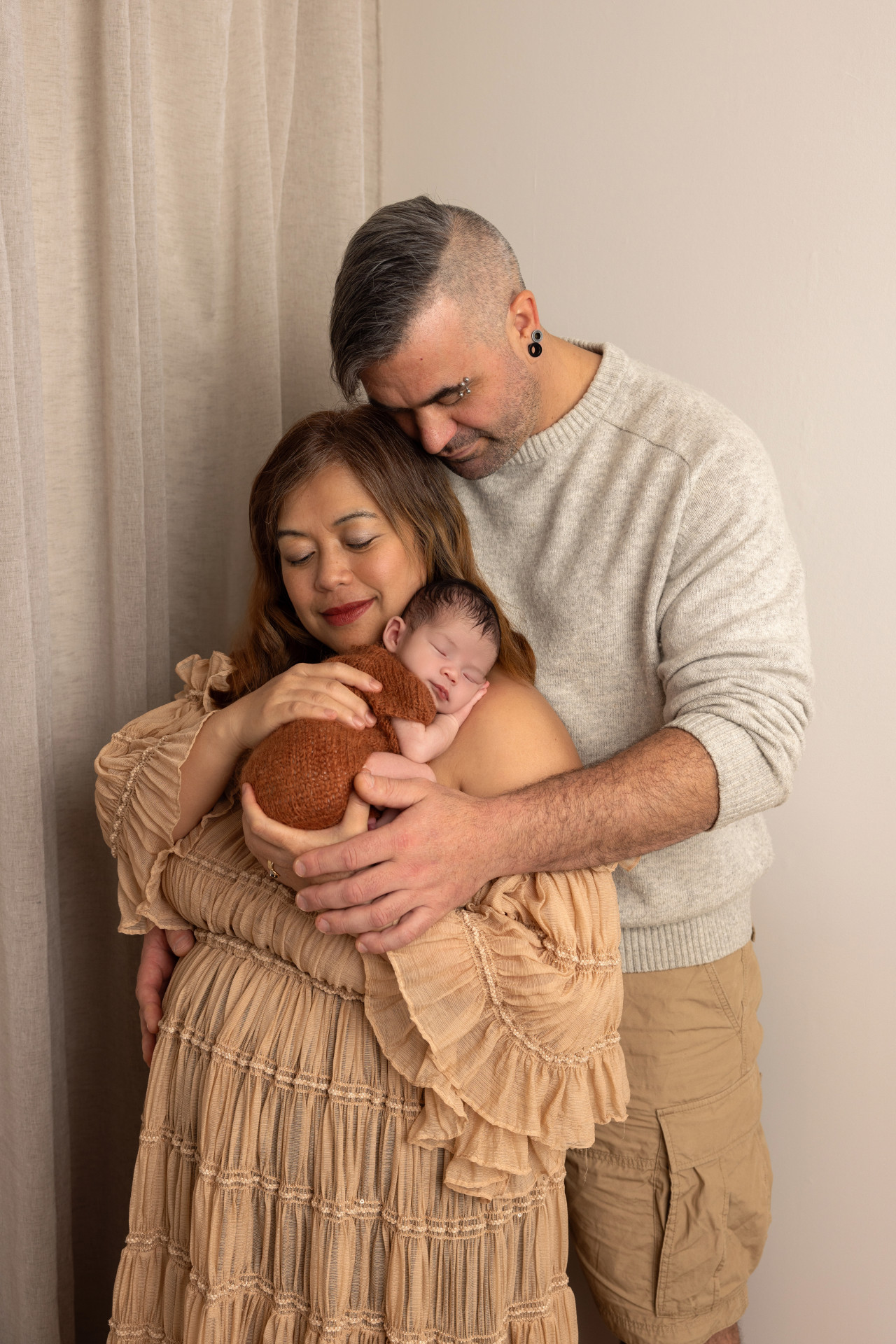 parents holding baby