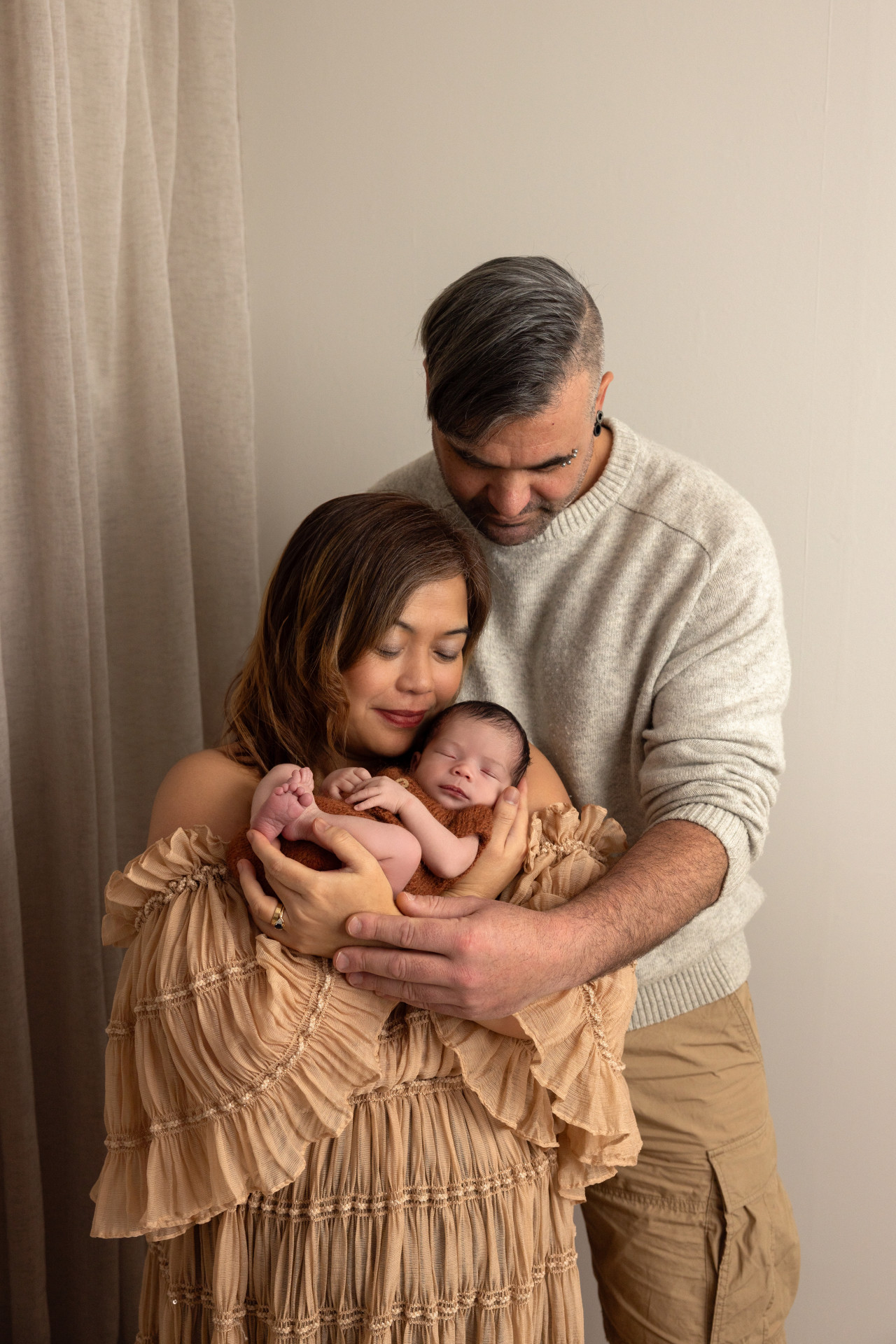 parents holding baby