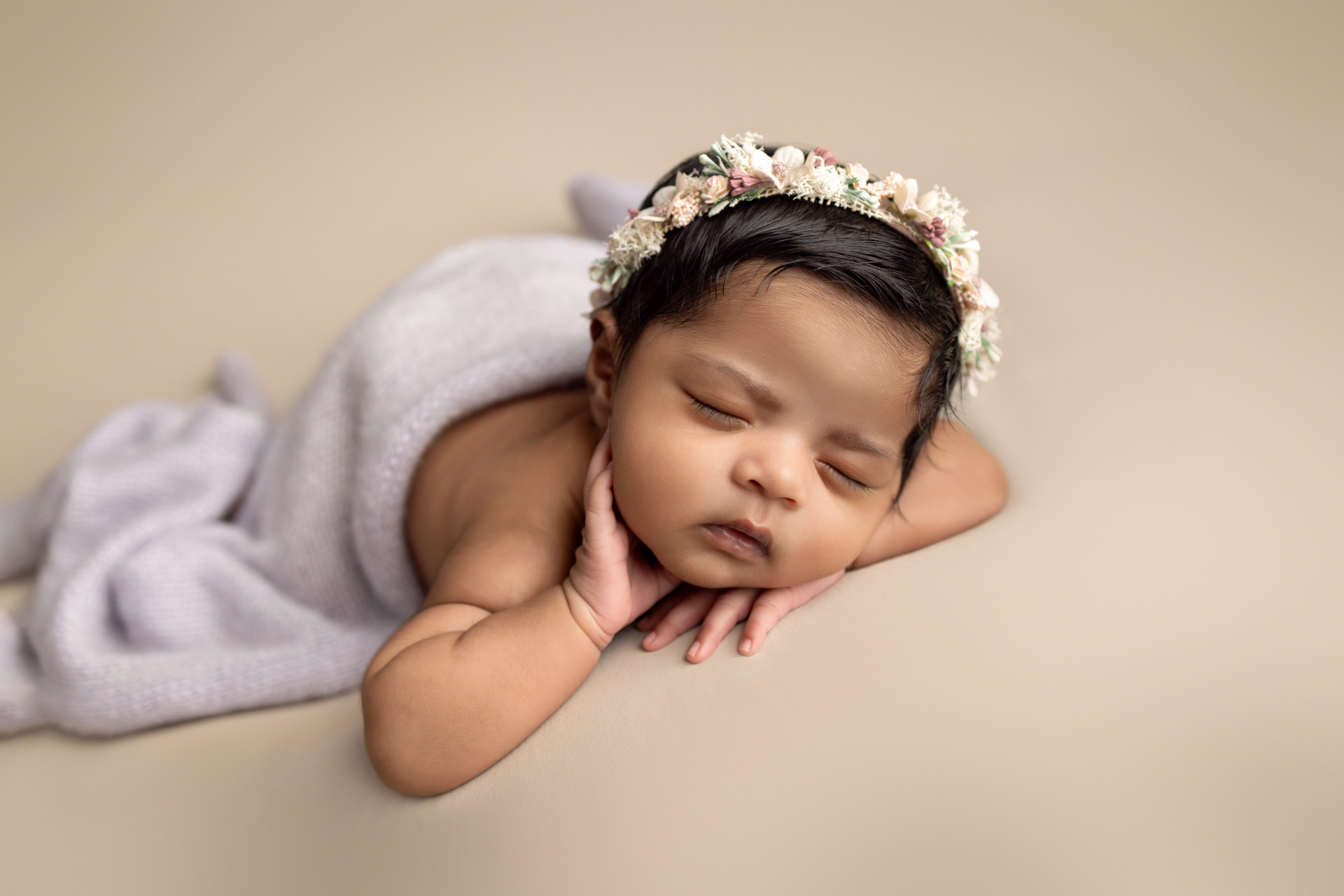 baby sleeping on his hands