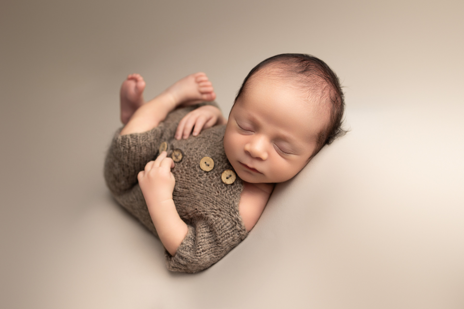 newborn in huck finn pose