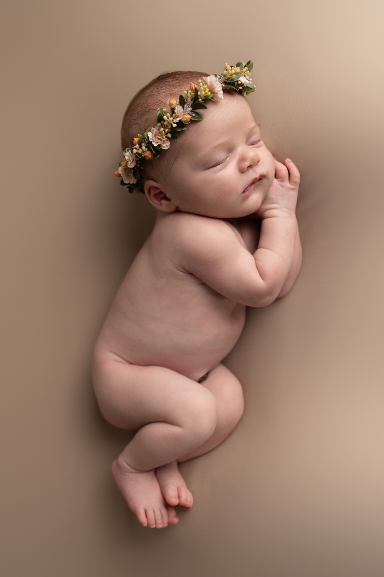 newborn sleeping on the side with floral crown