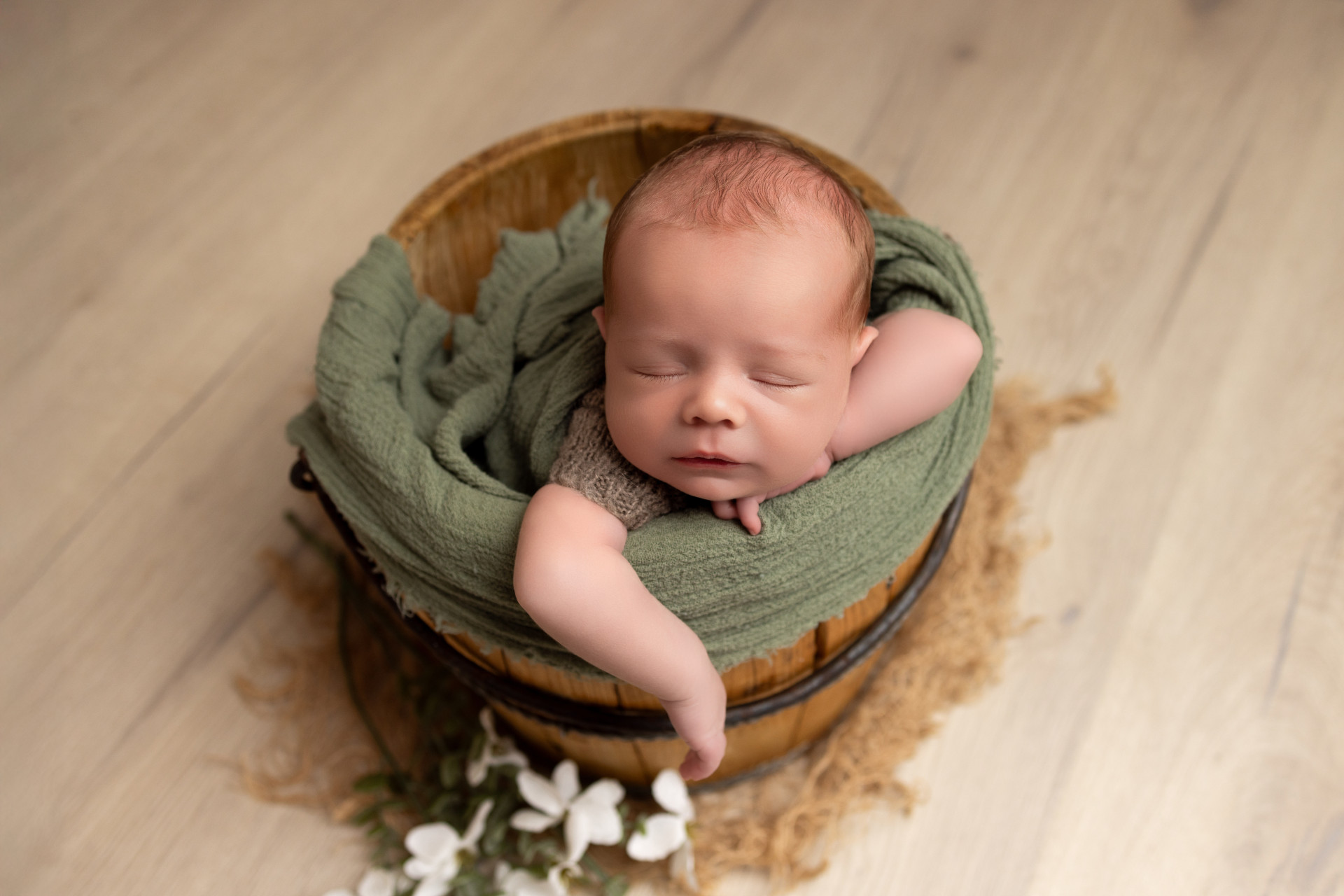 baby sleeping in the vintage wine bucket