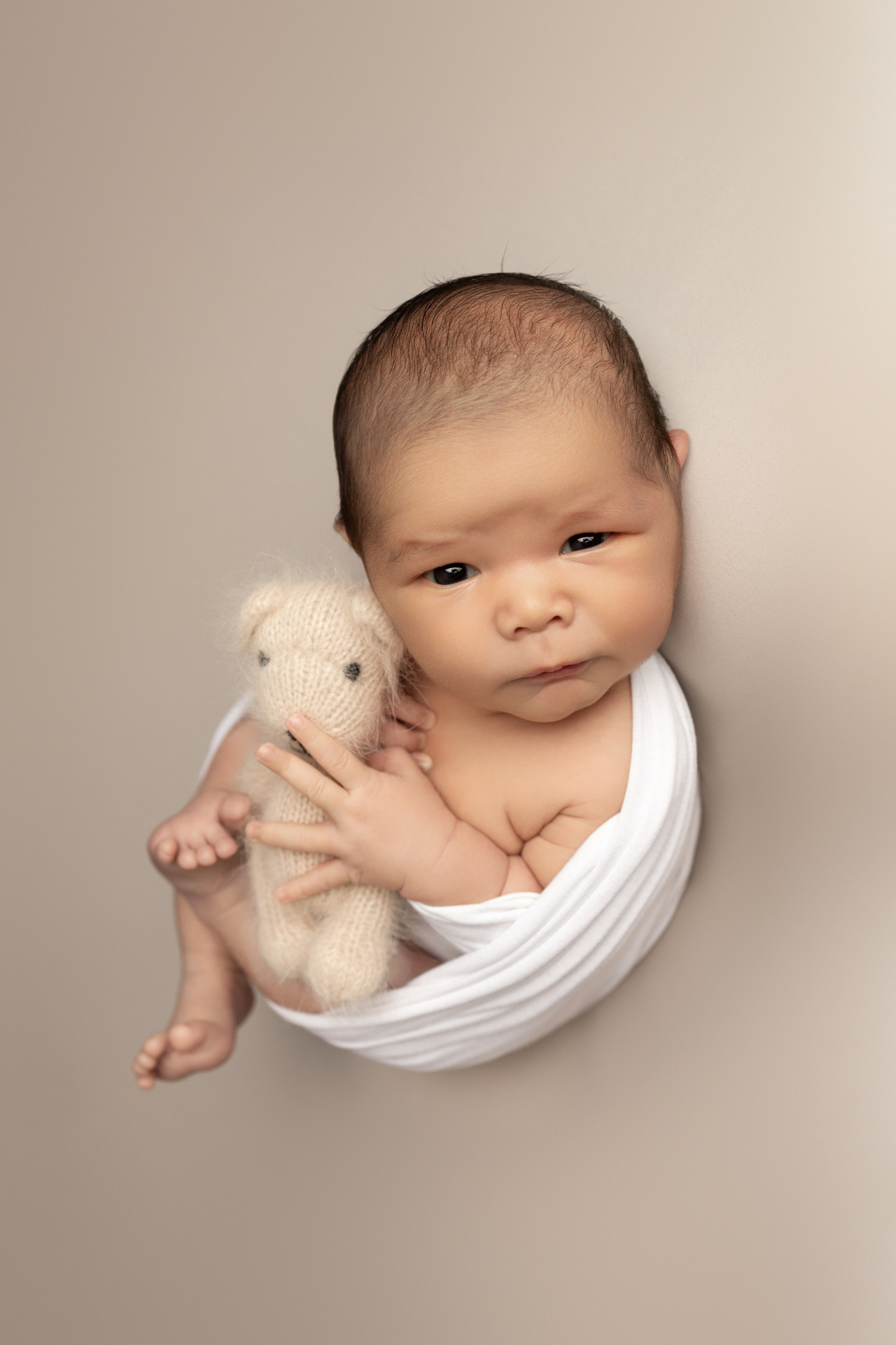 baby in egg wrap looking
