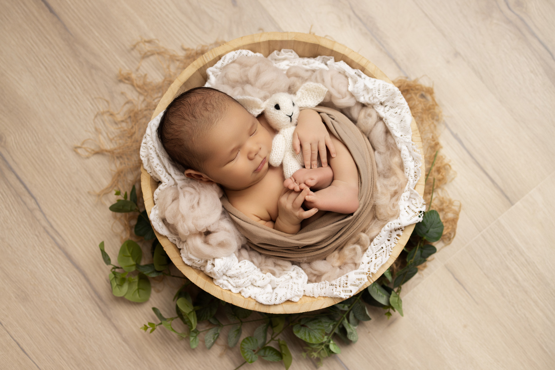 baby sleeping in round basket